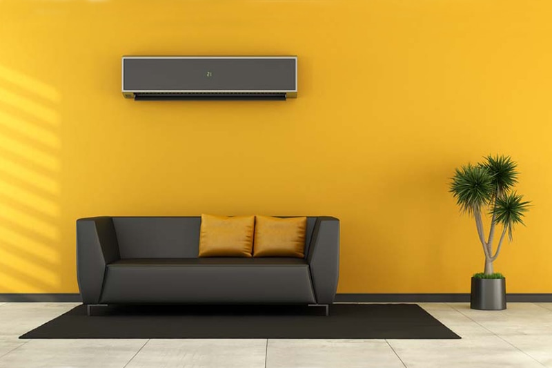 Custom ductless AC system mounted to wall above couch.