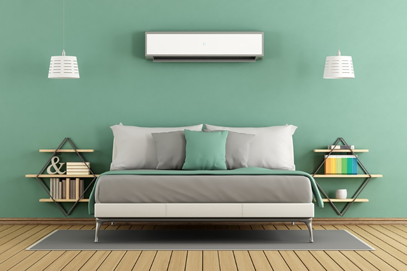 Custom ductless mini split mounted to wall above couch.