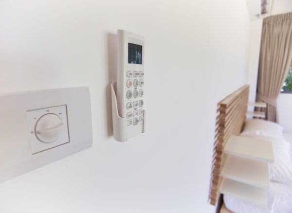 Controller mounted to wall to represent information on upgrading your thermostat.
