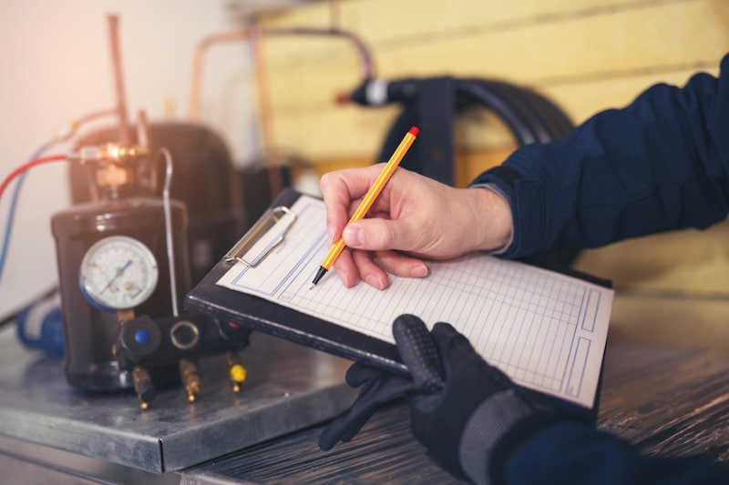HVAC technician performing a maintenance check to represent joining the HVAC industry.