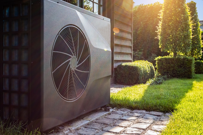 Custom heat pump outside home in Dumas, TX, representing transitioning to a new HVAC system.