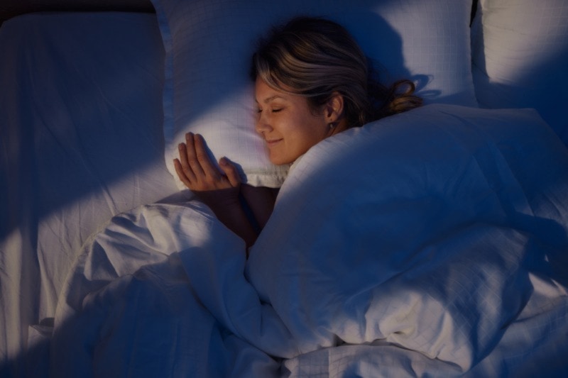 Your HVAC System Can Enhance Sleep. Woman sleeping peacefully in bed.