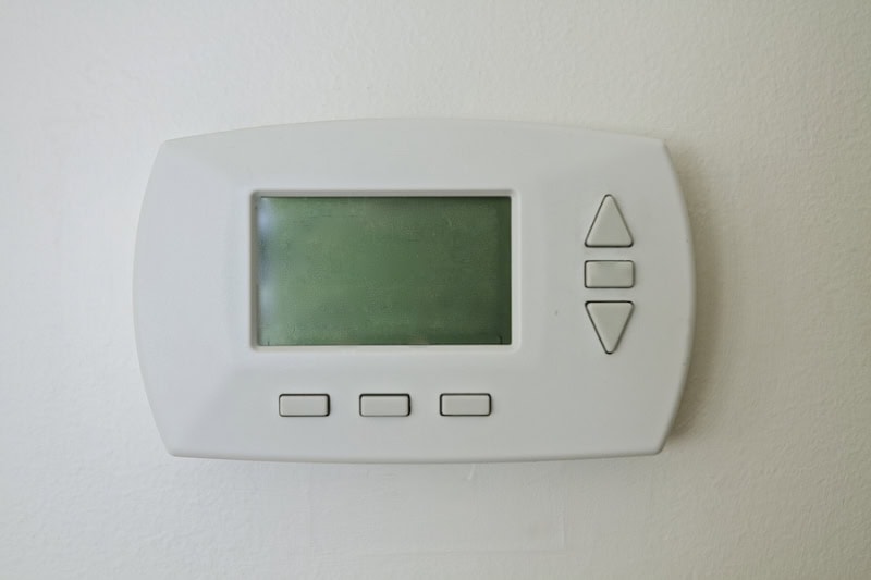 Example of a blank thermostat on wall in home.