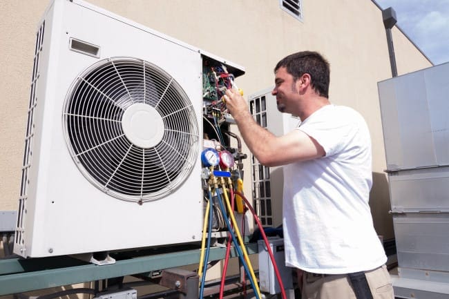 HVAC maintenance being performed on an outdoor unit in Dumas, TX.