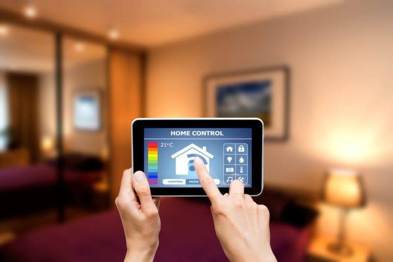 Homeowner using home automation through her smartphone.