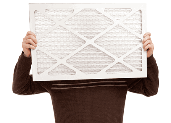 Person holding up a clean air filter to represent better indoor air quality.