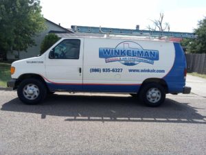 Winkelman Heating & Air Conditioning service van at residential home in Dumas, TX.
